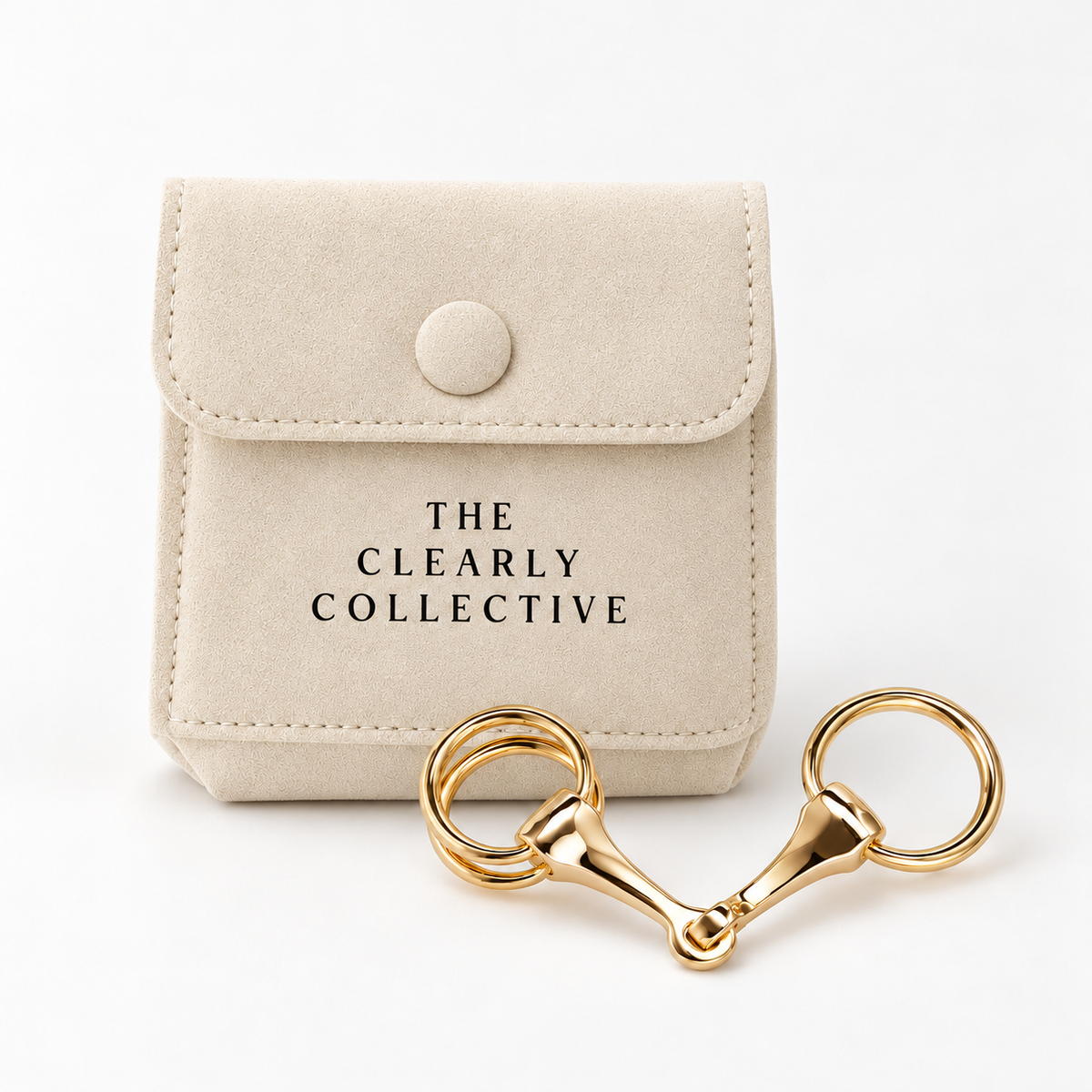 The Scarf Buckle on a cream suede bag